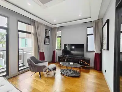 Modern living room with stylish furniture and large windows for natural light.