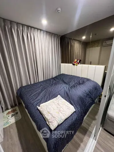 Cozy bedroom with elegant curtains and plush bedding in modern apartment