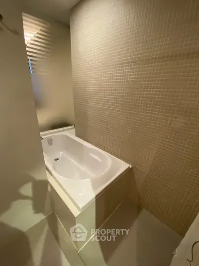Modern bathroom with sleek bathtub and stylish tile design
