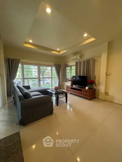 Spacious living room with modern decor and large windows for natural light.