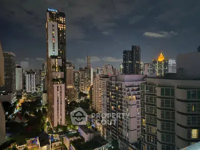 Stunning cityscape view from high-rise apartment at night, showcasing vibrant urban skyline.