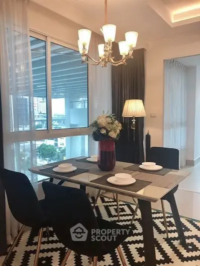 Stylish dining area with modern decor and city view, perfect for urban living.