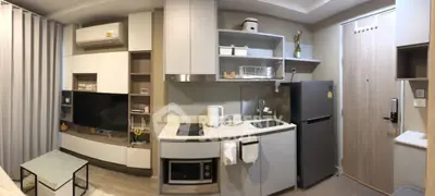 Modern compact kitchen with sleek cabinetry and integrated appliances in a cozy apartment.