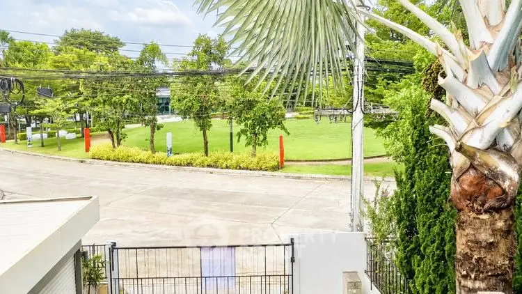 Scenic view from a property with lush greenery and a quiet street, ideal for serene living.