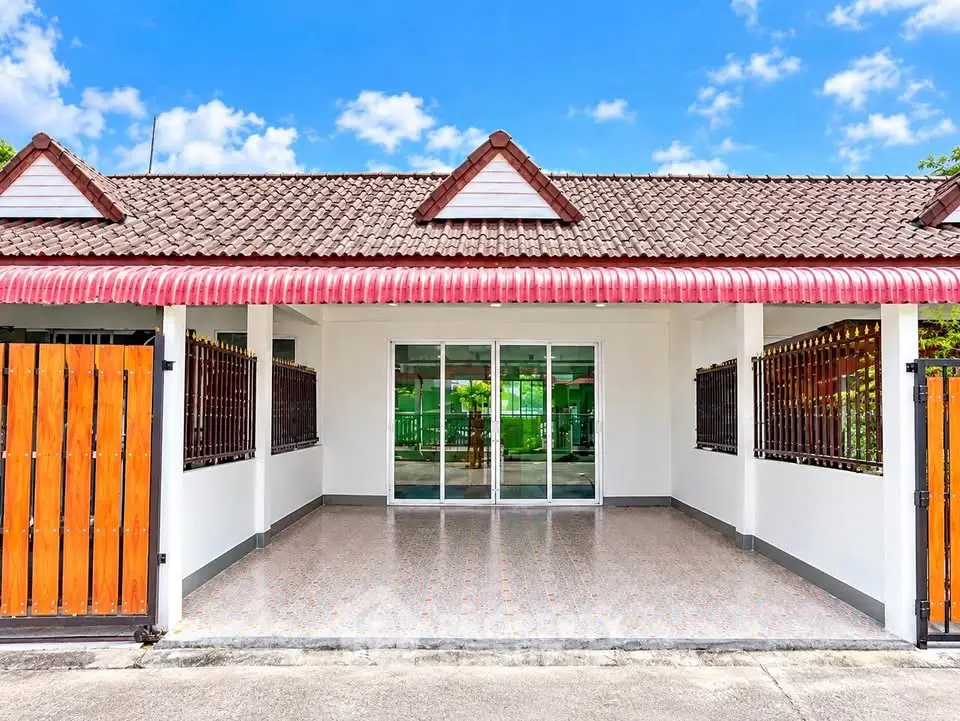 Charming single-story home with tiled roof and spacious front patio, perfect for family living.