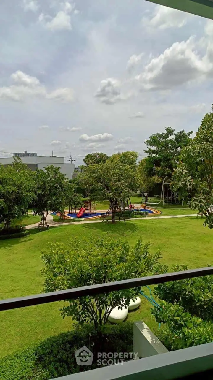 Spacious garden view with playground under a clear sky, perfect for family-friendly living.