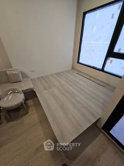 Modern minimalist room with elevated wooden platform and large windows