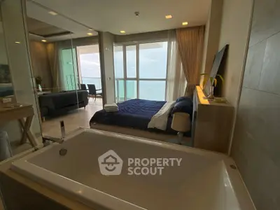 Luxurious beachfront bedroom with bathtub and stunning ocean view