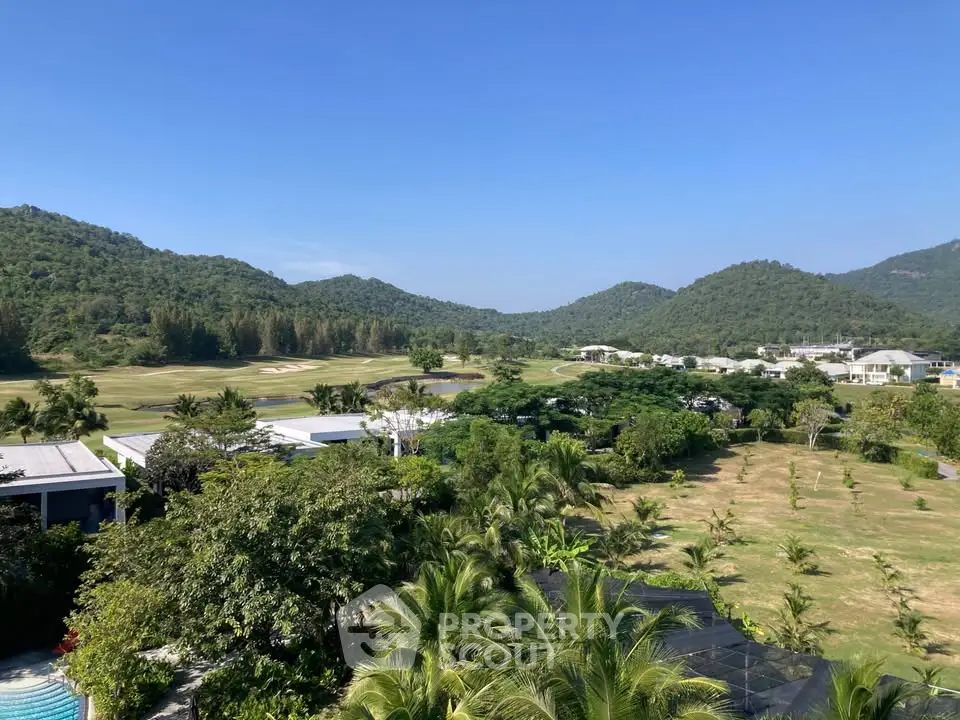 Stunning panoramic view of lush green landscape and mountains from a high vantage point.