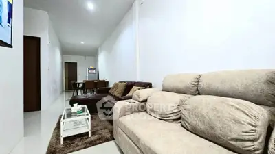 Spacious living room with modern furniture and dining area in open layout.