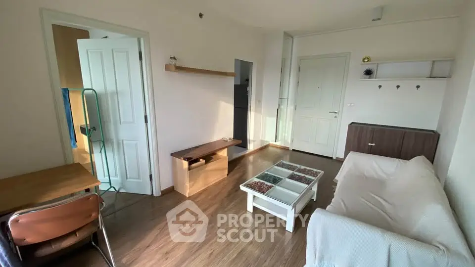 Cozy living room with modern furniture and wooden flooring in a stylish apartment.