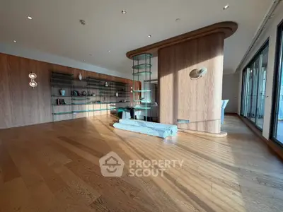 Spacious modern living room with wooden floors and stylish shelving