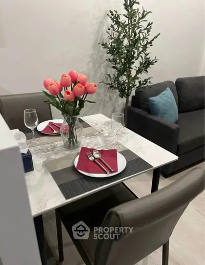 Chic dining area with elegant table setting and cozy seating in modern apartment.