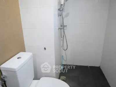Compact bathroom with shower and toilet in modern apartment