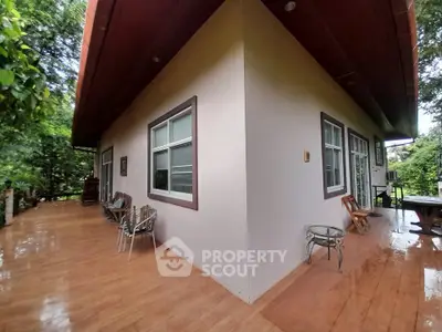 Charming corner unit with spacious outdoor patio and lush greenery, perfect for relaxation and entertaining.