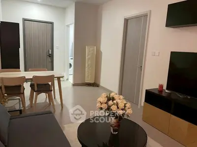 Modern living room with stylish furniture and open layout, featuring a cozy dining area and elegant decor.