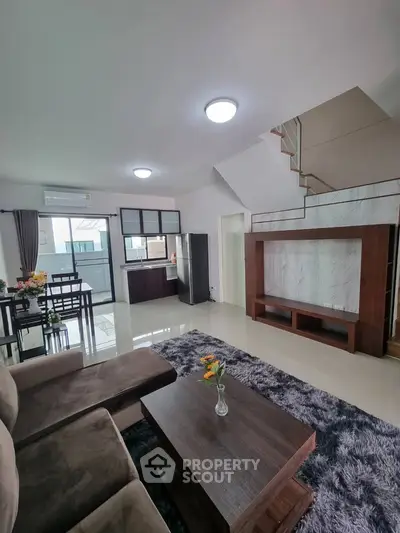 Spacious modern living room with open kitchen and stylish decor