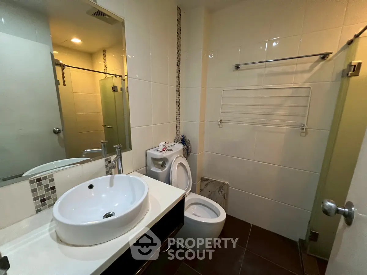 Modern bathroom with sleek fixtures and glass shower enclosure