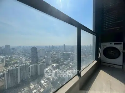 Stunning high-rise balcony with panoramic city view and modern washing machine.