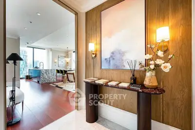 Elegant entryway with modern decor leading to spacious open-plan living area and kitchen.