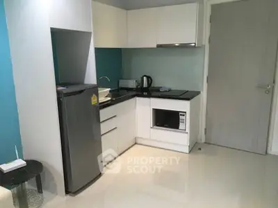 Modern compact kitchen with sleek appliances and minimalist design