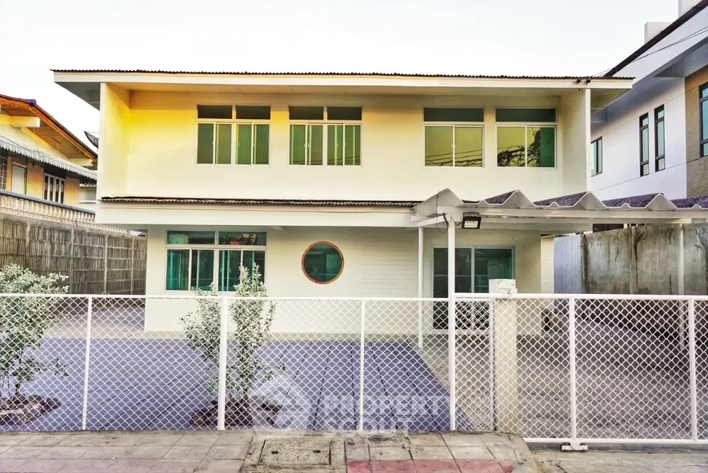 Charming two-story house with modern design and spacious front yard