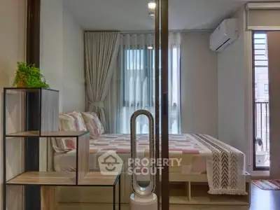 Modern bedroom with stylish decor and balcony access in a contemporary apartment.