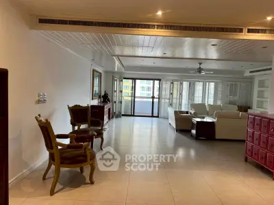 Spacious living room with elegant furniture and large windows in a modern apartment.