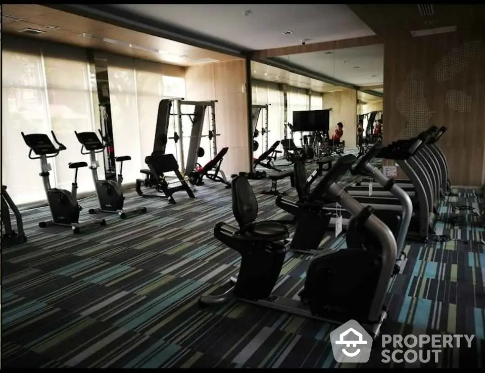 Modern gym with state-of-the-art fitness equipment and stylish interior design.