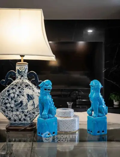 Elegant living room decor with blue ceramic statues and floral lamp