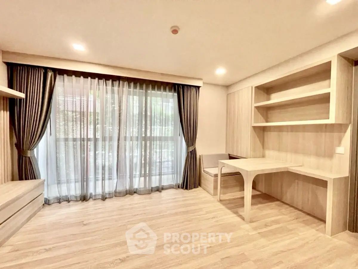Modern study room with large window and built-in desk in a stylish apartment