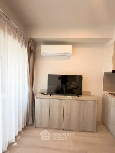 Modern living room with air conditioning and TV on wooden cabinet