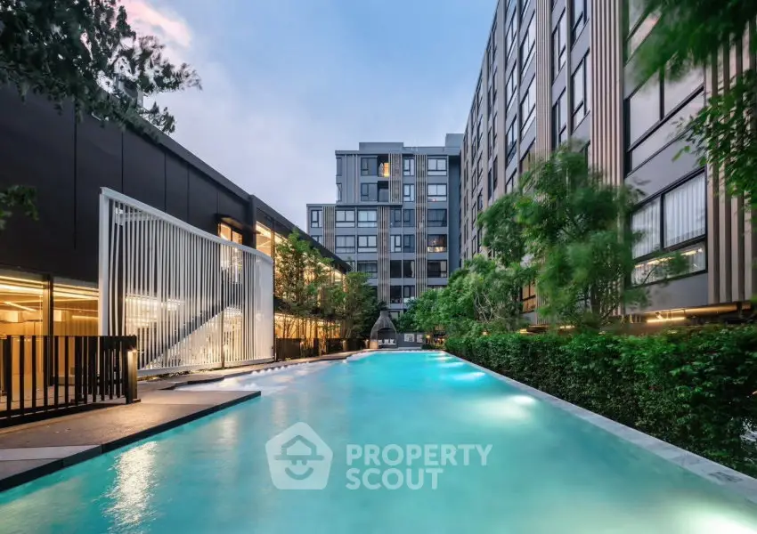 Luxurious modern apartment complex with stunning outdoor pool and lush greenery
