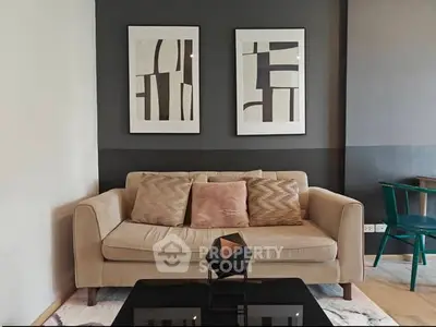 Modern living room with stylish beige sofa and abstract art decor
