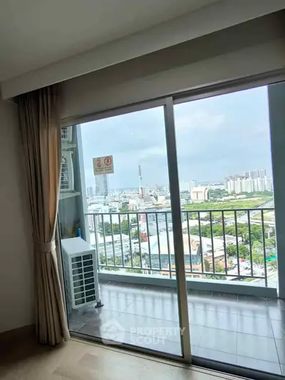Stunning high-rise apartment with panoramic city view from the balcony, perfect for urban living.