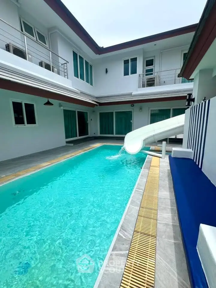 Luxurious modern home with private pool and slide, perfect for family entertainment.