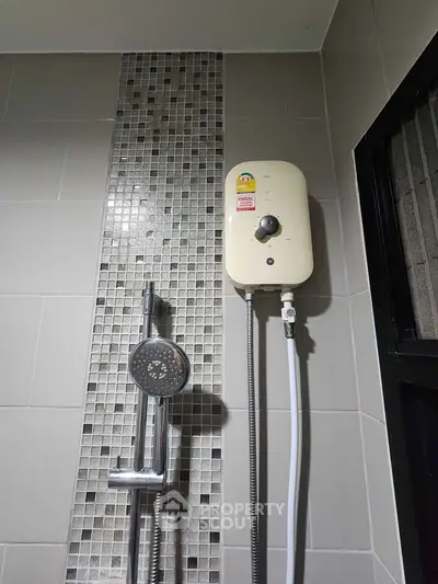 Modern bathroom shower with sleek tile design and water heater