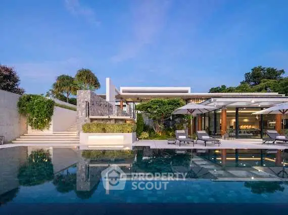 Luxurious modern villa with stunning pool and lush greenery, perfect for serene living.