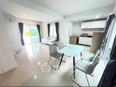 Modern open-plan living and dining area with sleek furniture and natural light.