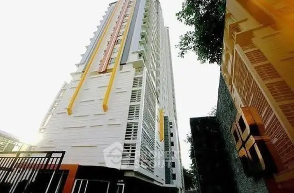 Modern high-rise building with unique architectural design and vibrant colors.