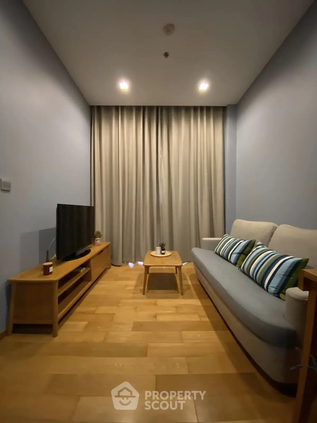 Cozy living room with modern decor and wooden flooring, perfect for relaxation and entertainment.