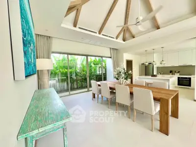 Luxurious open-plan living and dining area with high ceilings and modern decor
