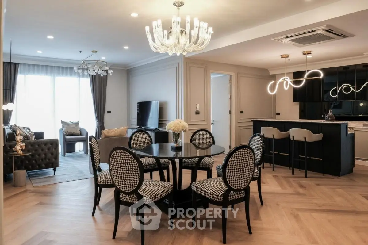 Luxurious open-plan living and dining area with elegant lighting and modern furnishings.