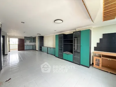 Spacious living room with built-in cabinets and tiled flooring, ideal for modern living.