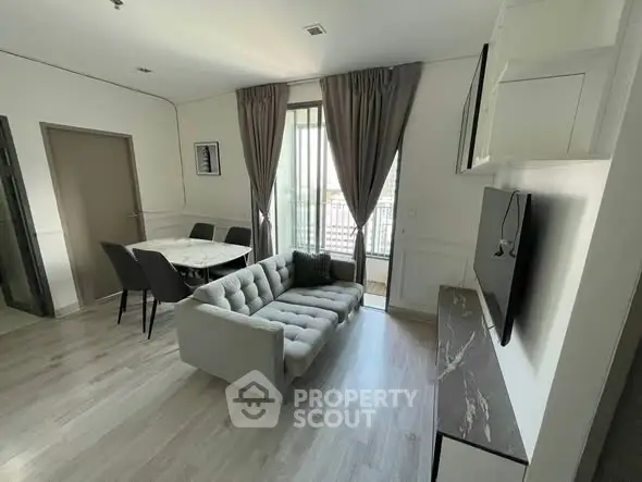 Modern living room with stylish furniture and large window view