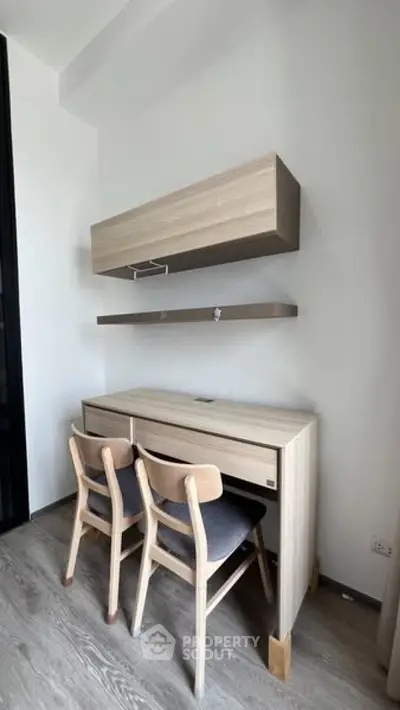 Modern study area with sleek wooden desk and chairs, perfect for productivity and style.
