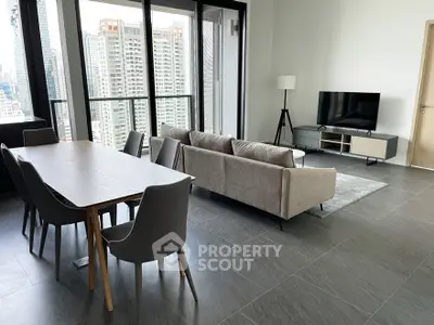 Modern living room with city view, sleek furniture, and large windows.