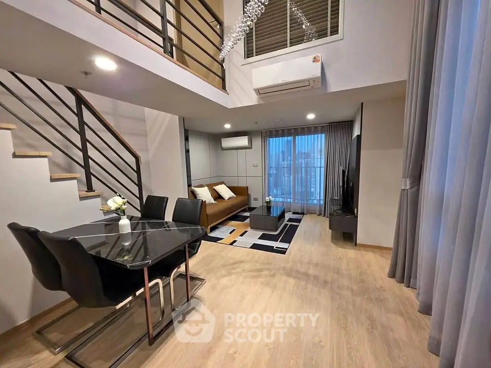 Modern duplex living room with stylish decor and open layout, featuring a dining area and cozy seating.