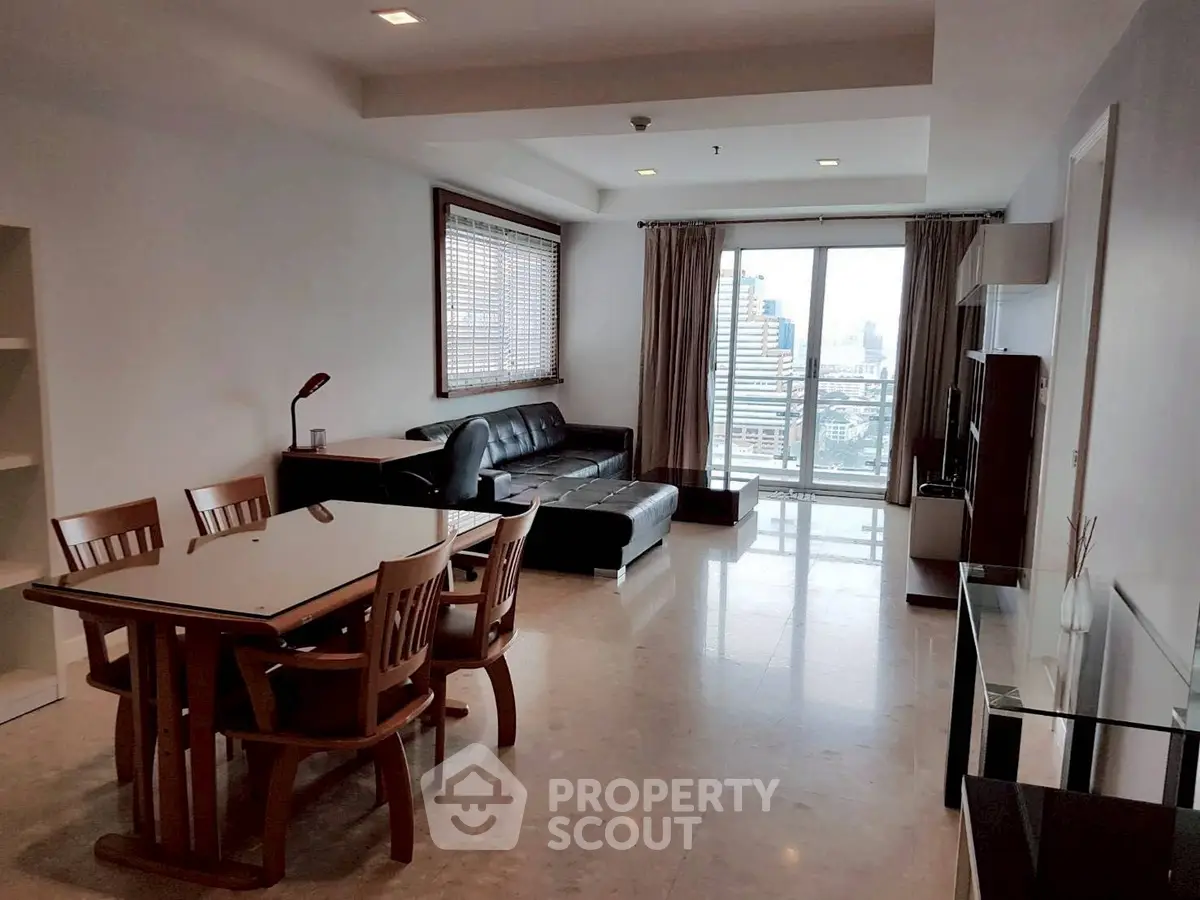 Spacious living room with city view, modern furniture, and natural light.