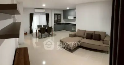 Spacious modern living room with open kitchen and stylish furniture